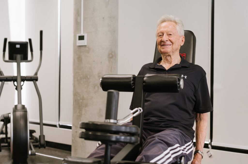 026 West lakes Physio_Hi Res Senior man doing leg exercises in physio supervised exercise class