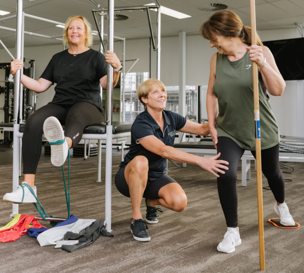 Particapants exercising in the GLA:D program with help from the Physiotherpist.