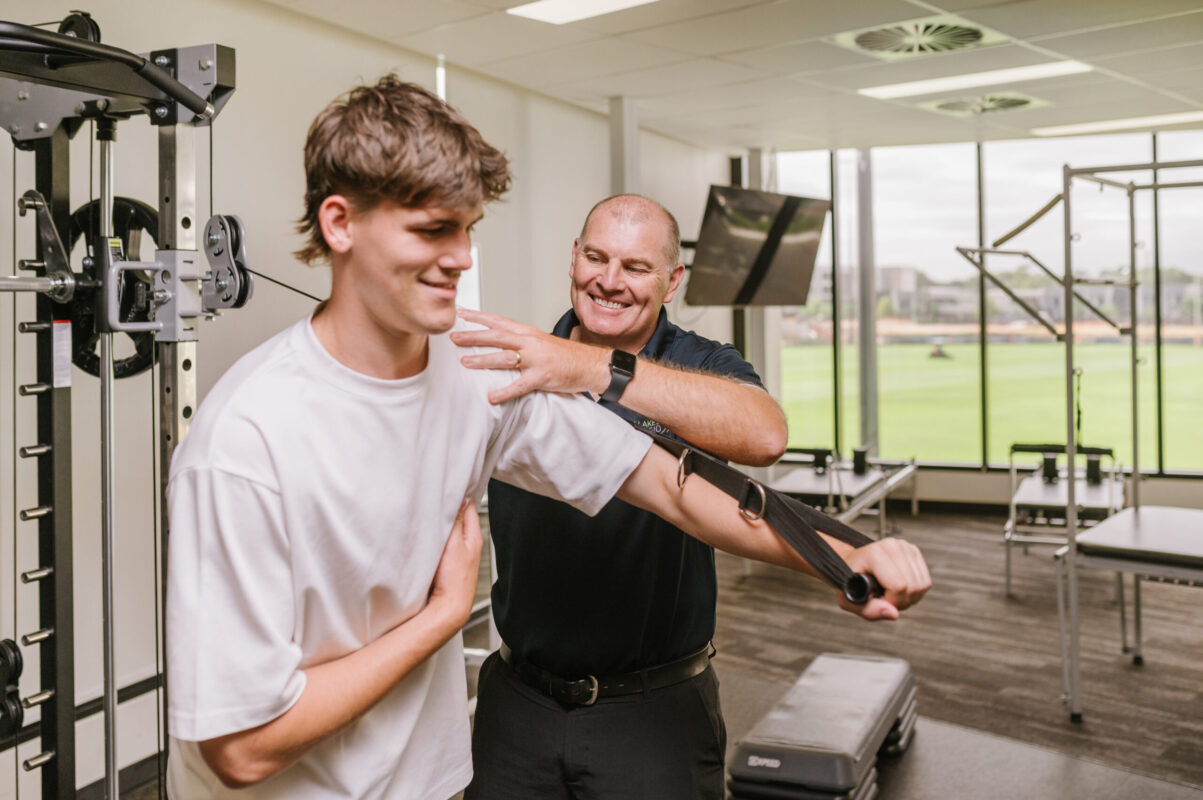 Physio assisting shoulder rehab after injury