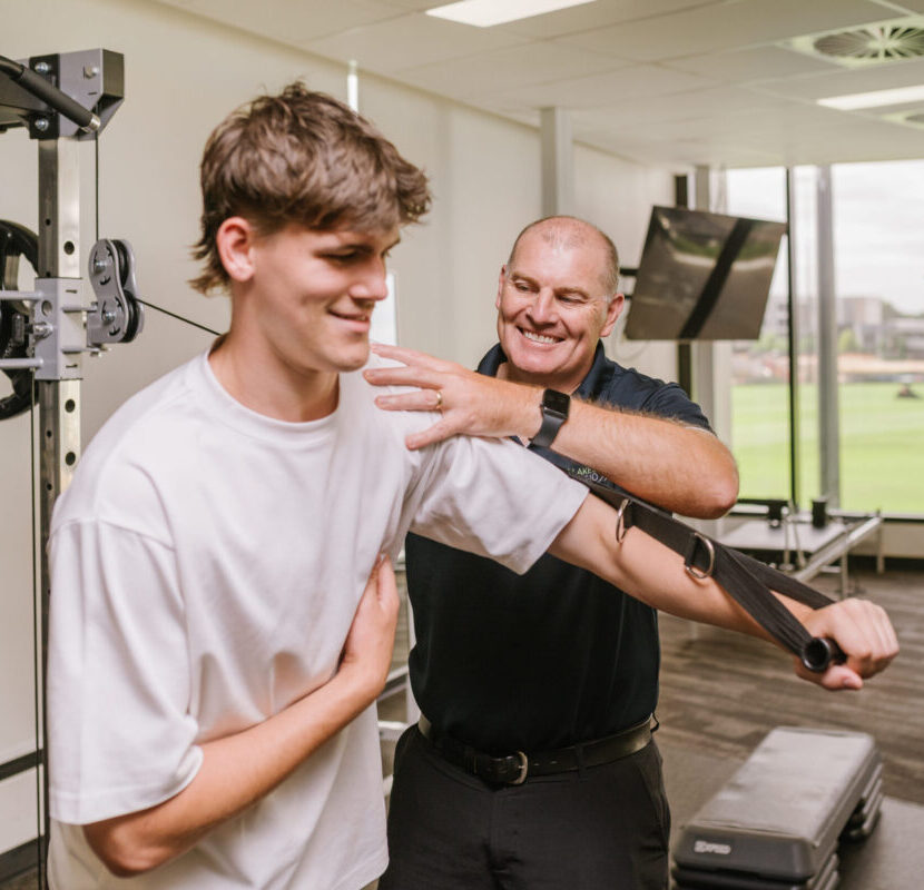 Physio assisting shoulder rehab after injury