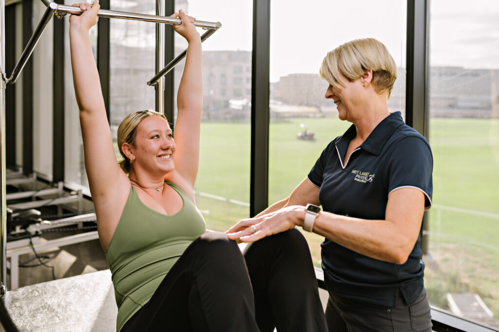 Physio assisting with exercises to help after an injury